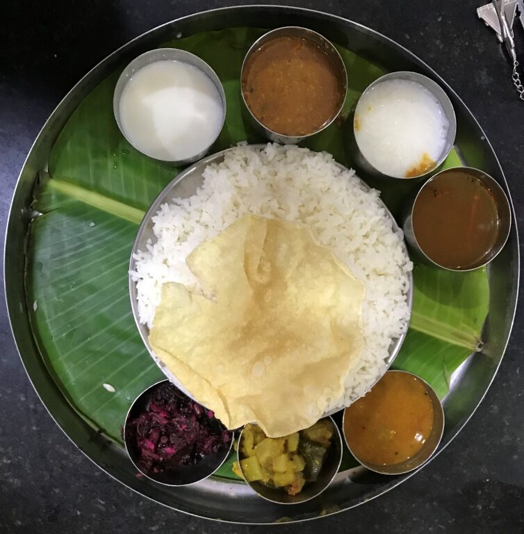 A vegetarian meal with rice, lentils and vegetable dishes